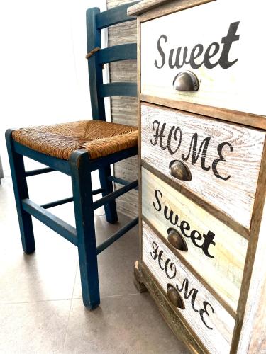 a dresser and a chair next to a dresser at Kostas Studios in Faliraki