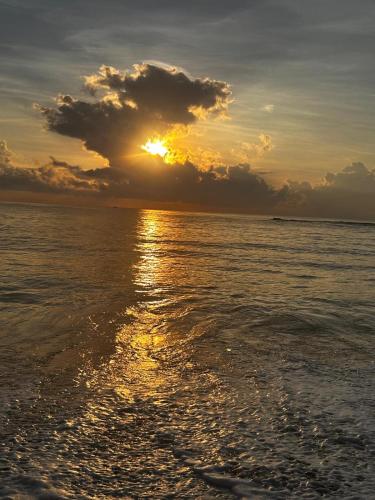 a sunset over the ocean with the sun setting at 108 Palms Beach Resort in Trincomalee
