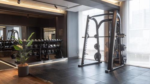 a gym with tread machines and a mirror at Shinagawa Prince Hotel in Tokyo