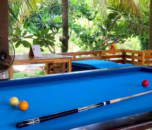 a pool table with a cue and balls on it at Me Bungalow Beach Resort in Phan Thiet