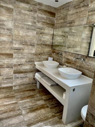 a bathroom with two sinks and a mirror at Kostas Studios in Faliraki