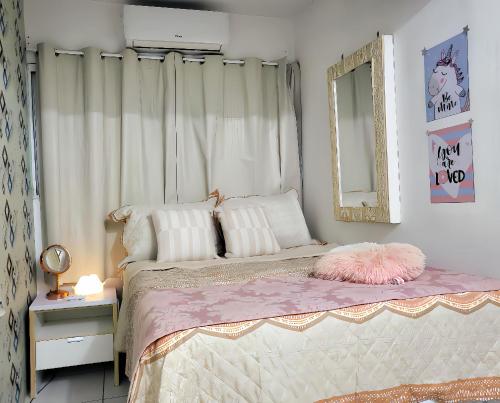 a bedroom with a bed with a mirror on the wall at Localização premium e Custo benefício imbatível! A 2min da praia de boa viagem - Apartamento completo-4 pessoas-Wi-Fi-Enxoval completo! in Recife