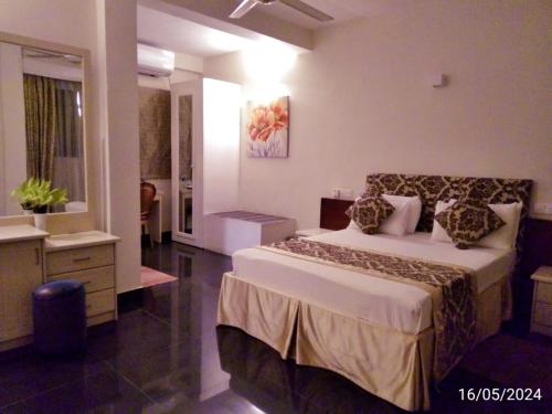 a bedroom with a large bed and a bathroom at Nilakma Lagoon in Negombo