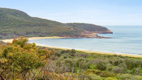 a view of a beach with trees and the ocean at 'Surfside' by HolidayCo in Killcare