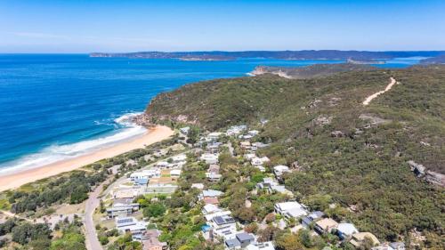 an aerial view of a beach with houses and the ocean at 'Surfside' by HolidayCo in Killcare