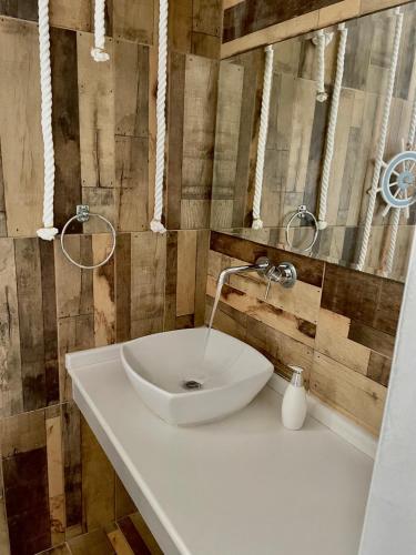 a bathroom with a white sink and a mirror at Kostas Studios in Faliraki