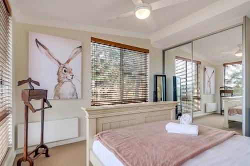 a bedroom with a bed and a large window at Escape To Narrabeen @ Sydney Northern Beaches - Home Away From Home in Narrabeen