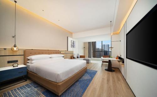 a bedroom with a bed and a flat screen tv at Four Points by Sheraton Chengdu, High-Tech Zone Exhibition Center in Chengdu