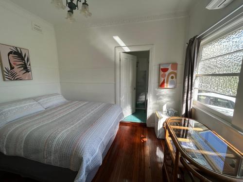 a bedroom with a bed and a window at Melville House Bed and Breakfast in Lismore
