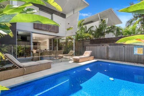 an exterior view of a house with a swimming pool at KoKo's Beach House 4 in Byron Bay