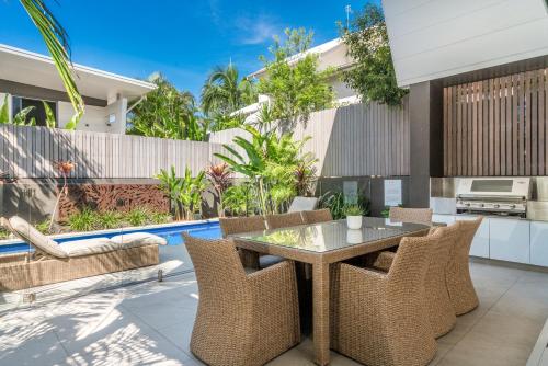 an outdoor patio with a table and chairs at KoKo's Beach House 4 in Byron Bay