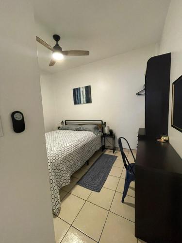 a bedroom with a bed and a ceiling fan at Villa Angel in Tijuana