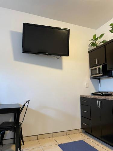 a room with a flat screen tv on a wall at Villa Angel in Tijuana