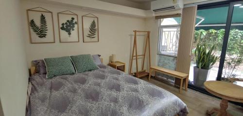a bedroom with a bed and a large window at Tai O Inn, by the Sea in Hong Kong