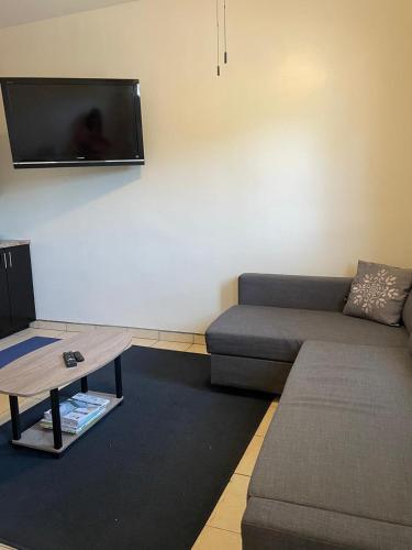 a living room with a couch and a flat screen tv at Villa Angel in Tijuana