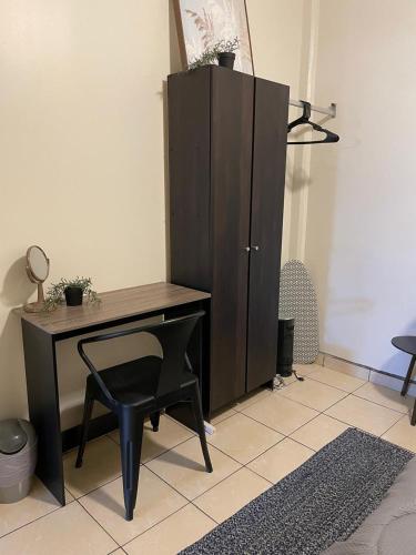 a desk with a chair next to a cabinet at Villa Angel in Tijuana