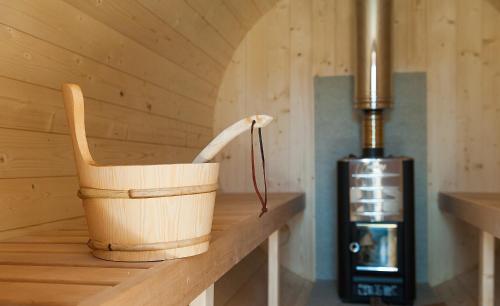 a wooden bucket sitting on a shelf in a sauna at Chalet Hovel in Mănăstirea Humorului