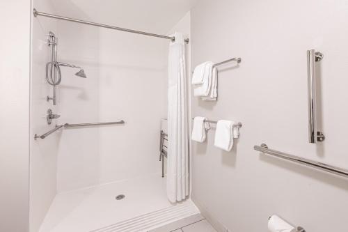 a white bathroom with a shower and a sink at Holiday Inn Express & Suites - Rantoul by IHG in Rantoul