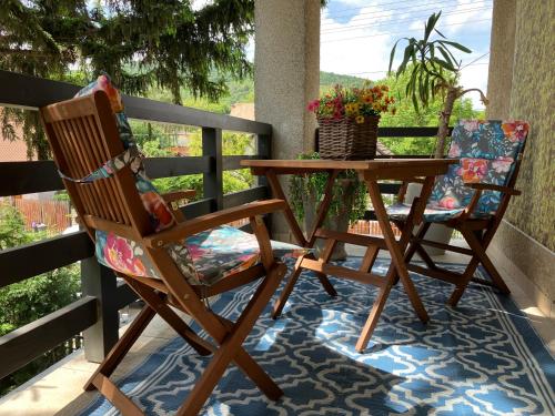 a rocking chair and a table on a porch at MemoriaMarci - Free Bikes, Danube Band & Pilis in Pilismarót