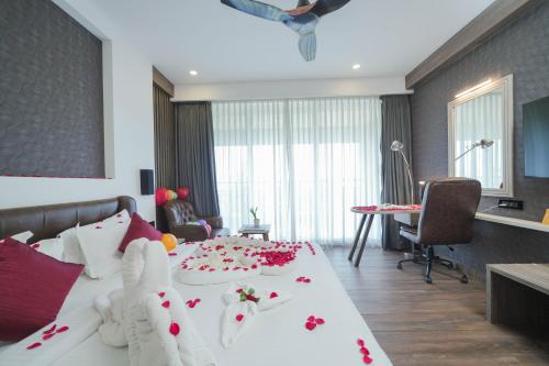 a bedroom with a large bed with flowers on it at Classic Regency in Alleppey