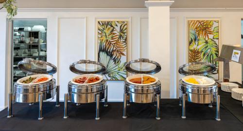 a group of drums with food in them at Hotel Armitage and Conference Centre in Tauranga