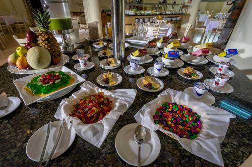 a table with many plates of food on it at Excelaris Grand Resort Conventions & Spa in Tequesquitengo