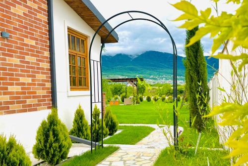 a garden with a view of a house at Entire Villa Near Tbilisi Nature Reserve with Panoramic View in Mtskheta