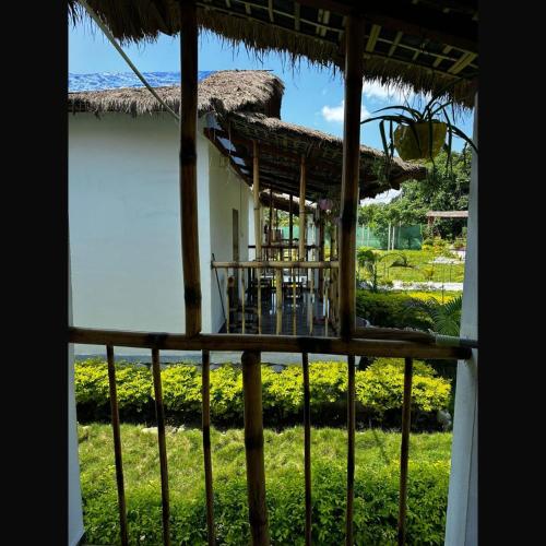 a view from a balcony of a house at Falcon Jungle Resort in Jyoti Gaon