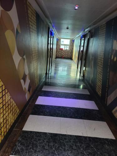 a hallway in a building with colorful floors and walls at Geoje King motel in Geoje 