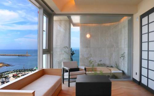 a living room with a view of the ocean at Ije Busan in Busan