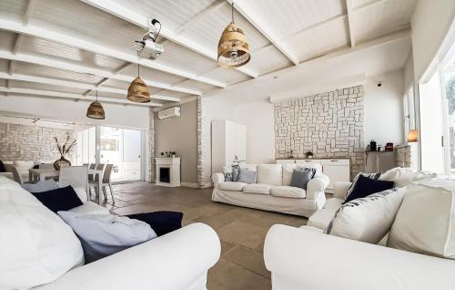 a living room with white couches and a table at 1 Bedroom Awesome Home In Leporano in Leporano