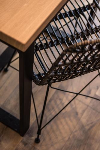 a wooden table with a wooden bench next to a table at Polpo Apartments B&B in Łódź