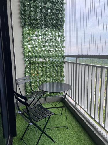 a table and a chair on a balcony at Damai Antara Homestay in Putrajaya