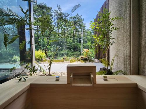 a room with a bench in front of a large window at Ije Busan in Busan