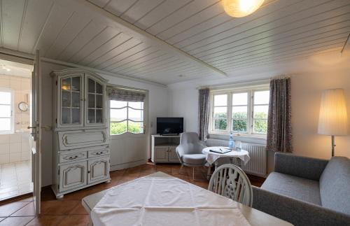 a living room with a couch and a table at Haus Amanda in Norddorf
