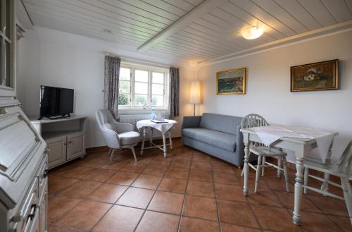 a living room with a couch and a table at Haus Amanda in Norddorf