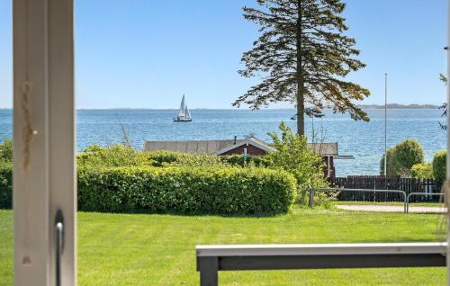 a view of the ocean from a house with a bench at Nice Home In Hesselager With Wifi in Hesselager