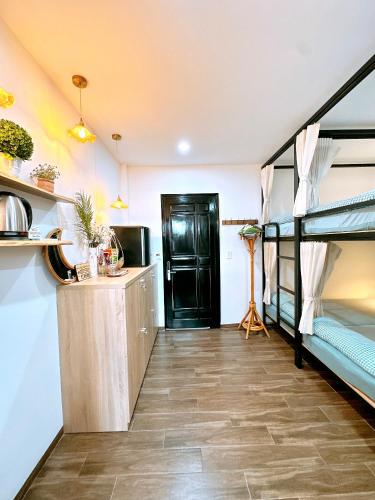 a room with a kitchen and a bunk bed at Moon Homestay in Thôn Kim Long (1)