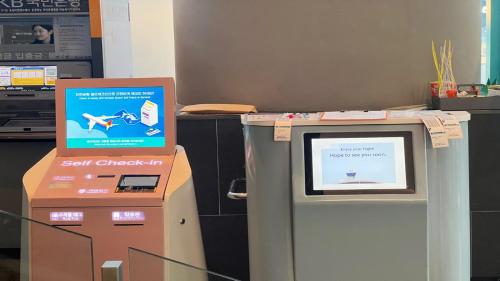 a self check in machine next to a box at Holiday Inn Express Seoul Hongdae by IHG in Seoul