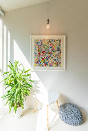 a painting in a white room with a plant at Flower Base Lily House in Fukuoka