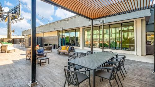 a patio with a table and chairs and a building at Holiday Inn Dallas Market Ctr Love Field by IHG in Dallas