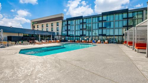 a swimming pool in front of a building at Holiday Inn Dallas Market Ctr Love Field by IHG in Dallas