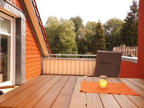 a wooden deck with a table with a candle on it at Holiday apartment Haus Bodefurt - Apartment 2 in Altenbrak