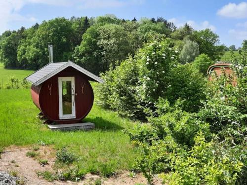 a small house in the middle of a field at Tiny House "Ria" Comfortable holiday residence in Miekenhagen