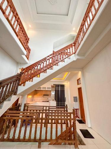 a row of benches in a room with a staircase at Teras Senja Sikunir Homestay in Kejajar