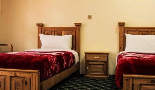 Ένα ή περισσότερα κρεβάτια σε δωμάτιο στο HUNZA Mountain HOTEL