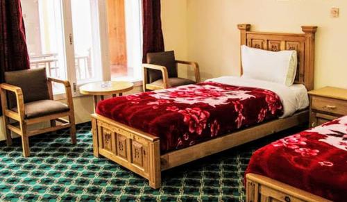 Ένα ή περισσότερα κρεβάτια σε δωμάτιο στο HUNZA Mountain HOTEL