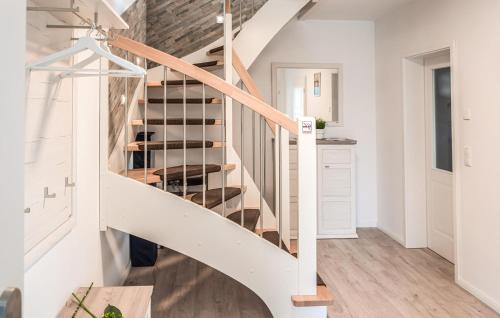 a staircase in a home with white walls and wood floors at Beautiful Home In Jesendorf With Sauna in Jesendorf