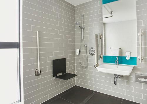 a bathroom with a sink and a shower at Holiday Inn Express Ajaccio by IHG in Ajaccio