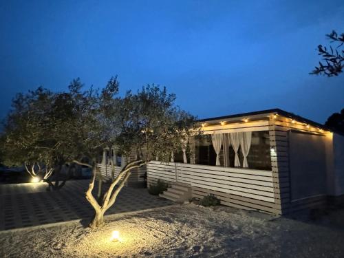 a house with a tree in front of it at night at Marty House Drage in Drage